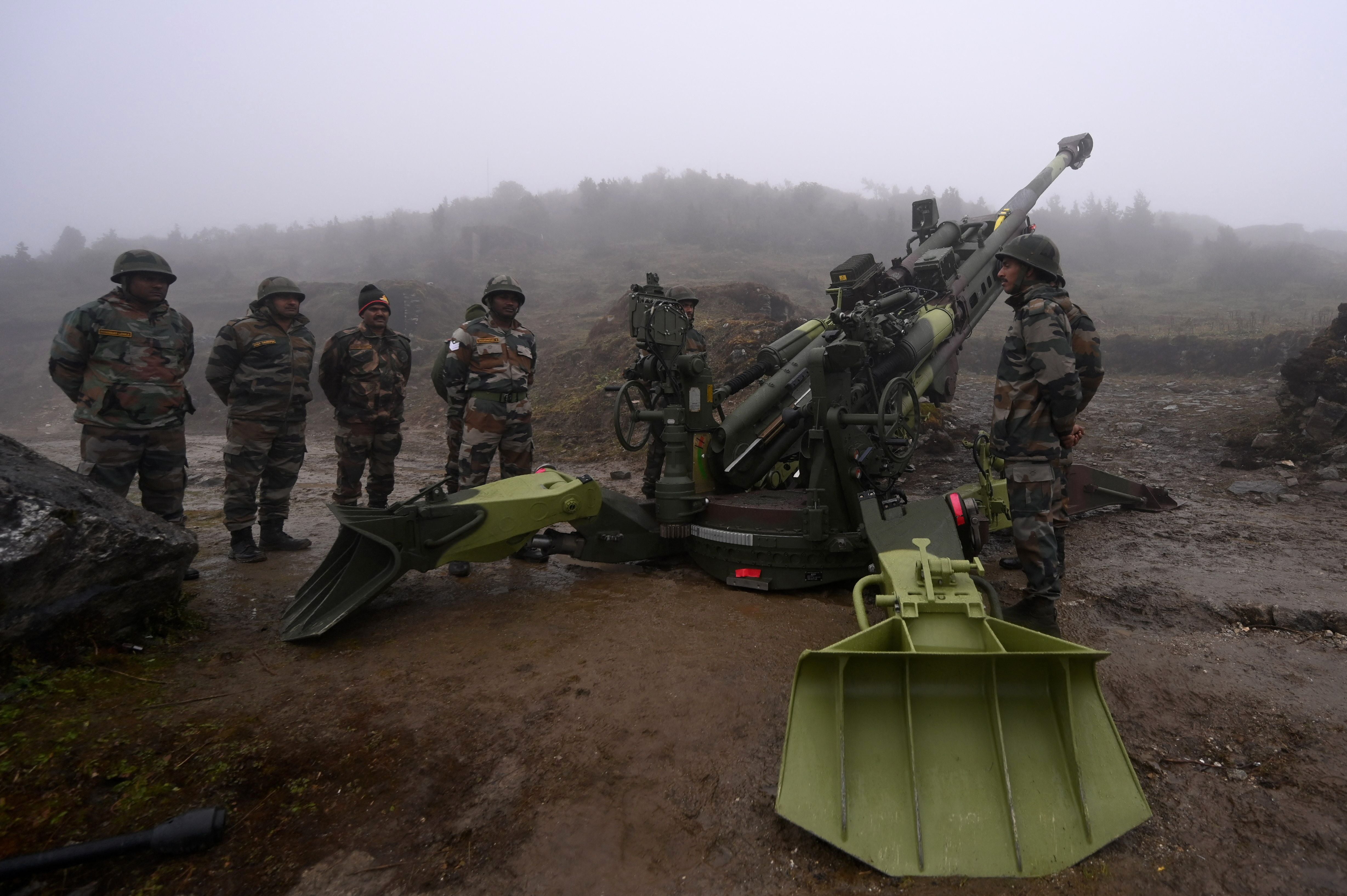 Indian soldiers next to a M777 Ultra Lightweight Howitzer near the Line of Actual Control (LAC) with China, in India’s Arunachal Pradesh state on 20 October 2021