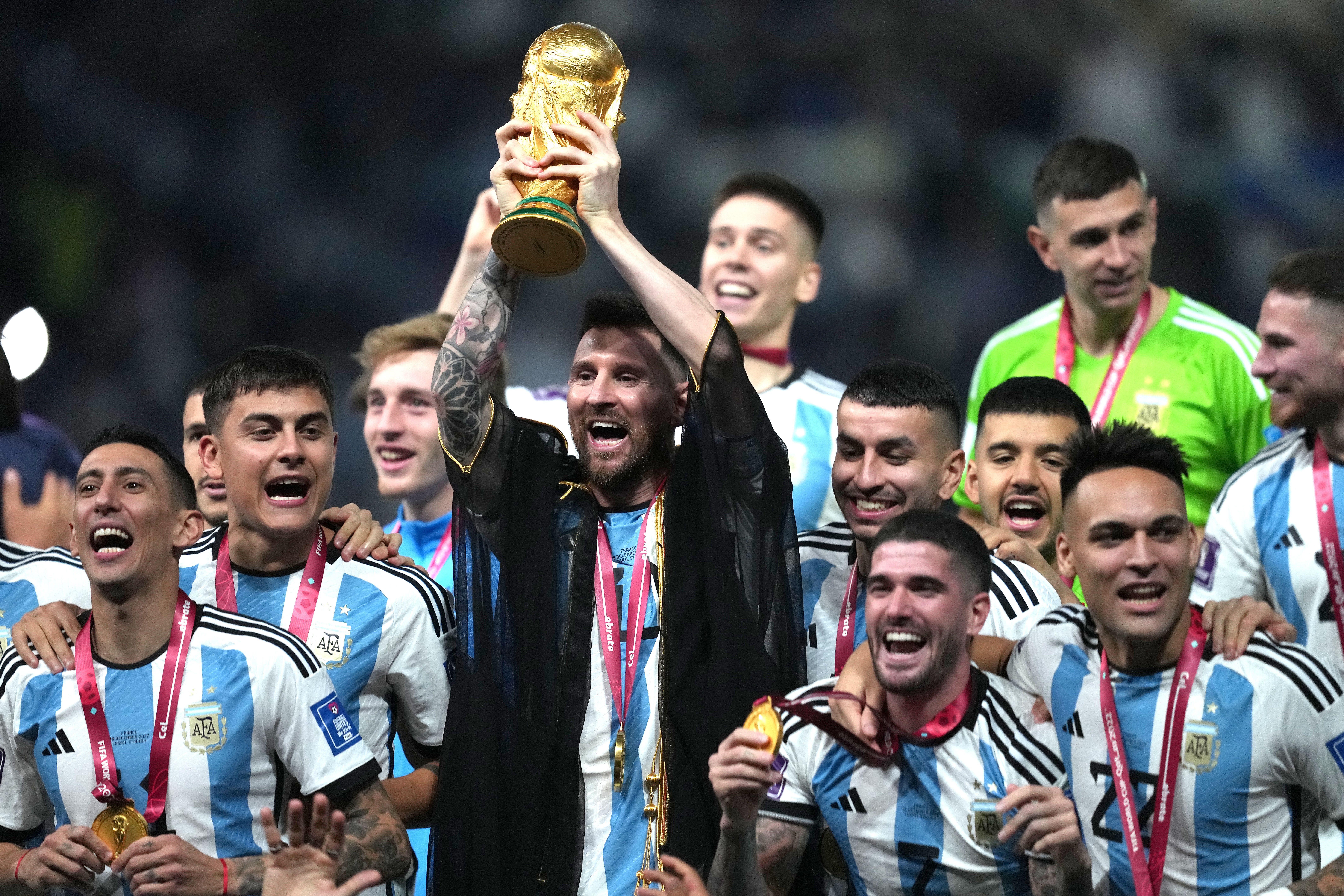 Argentina captain Lionel Messi lifts the World Cup trophy after a penalty shoot-out victory over France (Martin Rickett/PA)