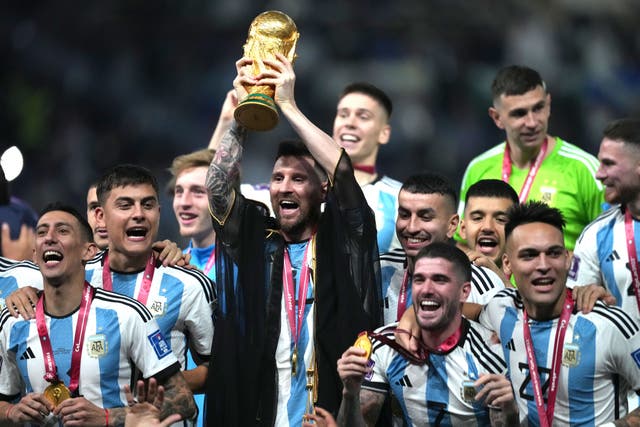 Argentina captain Lionel Messi lifts the World Cup trophy after a penalty shoot-out victory over France (Martin Rickett/PA)