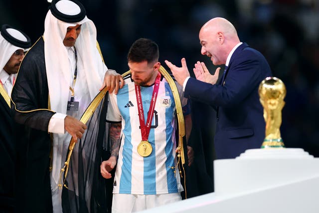 <p>A robe is put on Argentina’s Lionel Messi by the emir of Qatar Sheikh Tamim bin Hamad Al Thani</p>