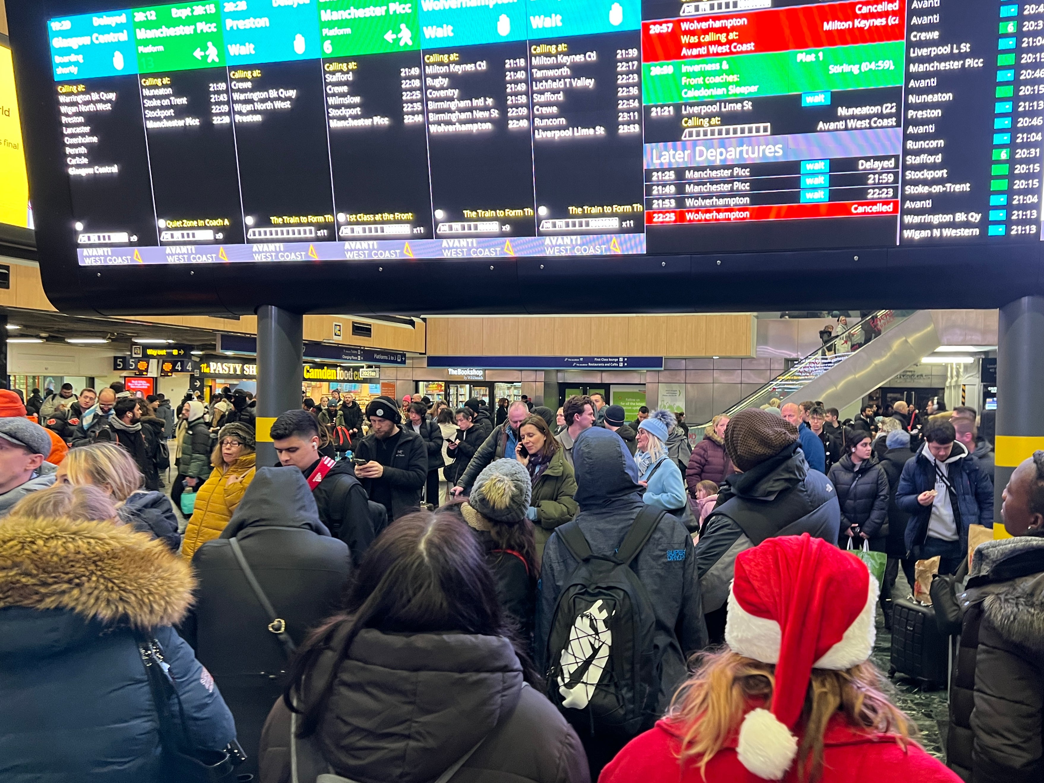 Comfort and joy? Passengers at London Euston station on Sunday night as delays and cancellations continued