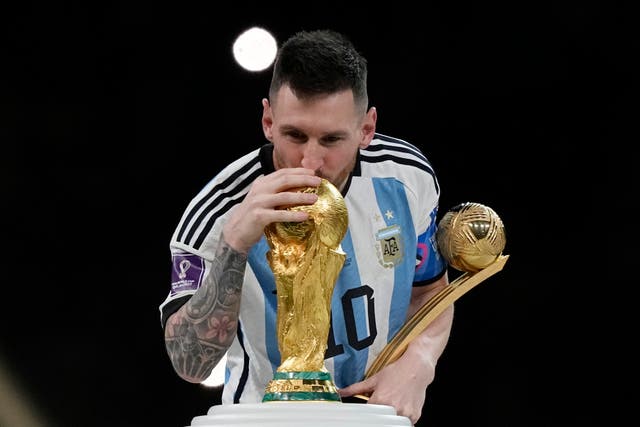 <p>Argentina’s Lionel Messi kisses the trophy after winning the World Cup</p>