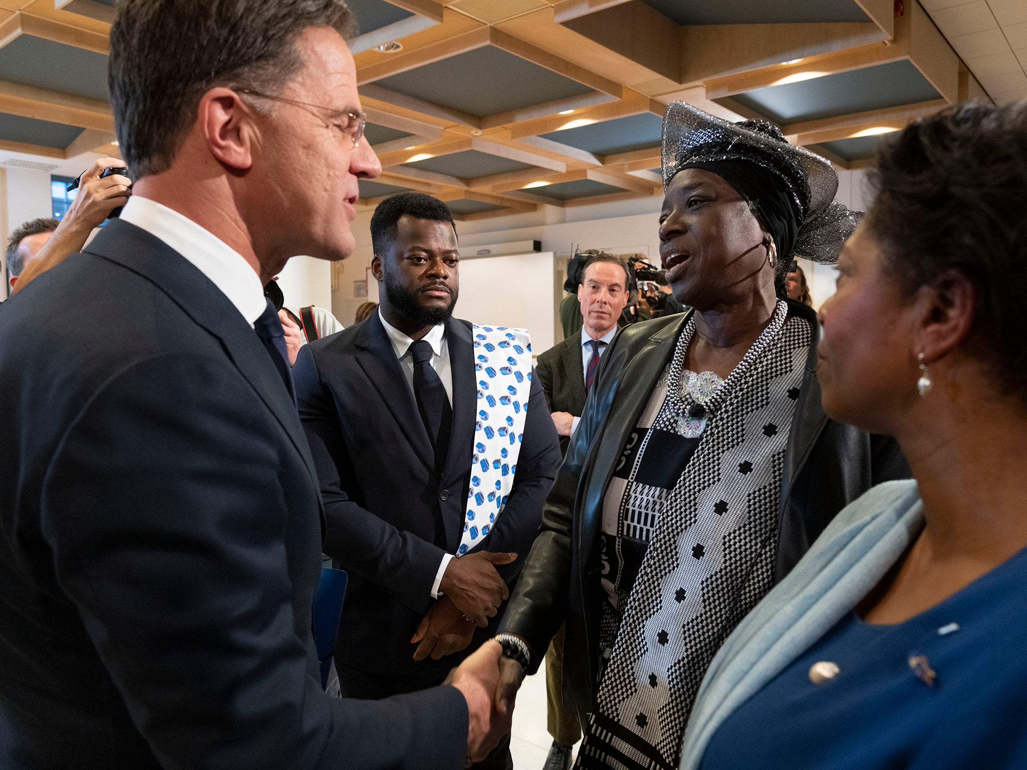 Dutch PM Rutte, left, shakes hands with Marian Markelo, a Winti Priest, an Afro-Surinamese traditional religion, second right, after apologising for the Netherlands’ historical role in slavery
