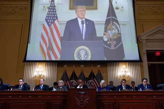 <p>Members of the U.S. House Select Committee investigating the January 6 Attack on the U.S. Capitol sit beneath an image showing former President Donald Trump speaking from the White House as they hold their final public meeting to release their report on Capitol Hill in Washington, U.S., December 19, 2022.</p>