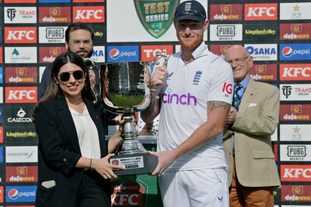 England captain Ben Stokes, right, receives the trophy (Fareed Khan/AP)