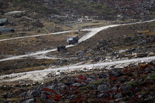 <p>An Indian army truck drives along a road to Tawang, near the Line of Actual Control (LAC), neighbouring China, near Sela Pass in India’s Arunachal Pradesh state </p>