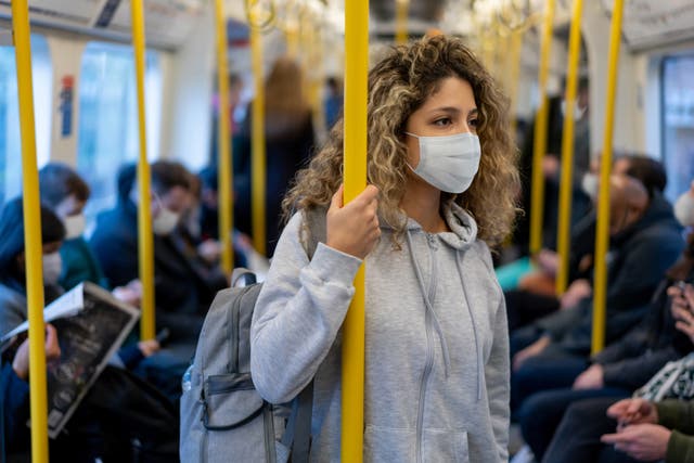 <p>A woman where a Covid mask on the London Underground </p>