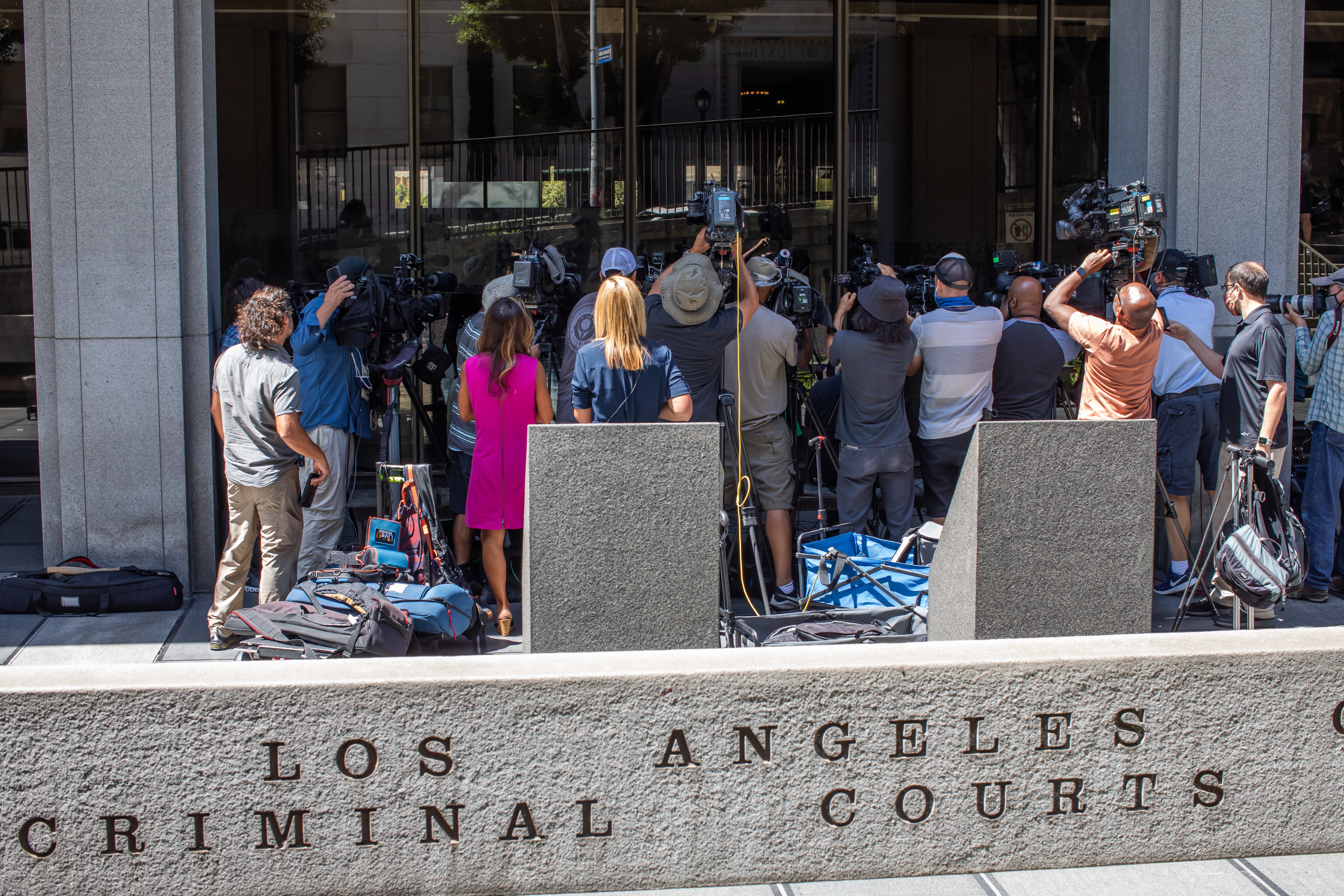 Journalists gather around attorney Gloria Allred at the Clara Shortridge Foltz Criminal Justice Center during the arraignment of former Hollywood producer Harvey Weinstein on 21 July 2021 in Los Angeles, California