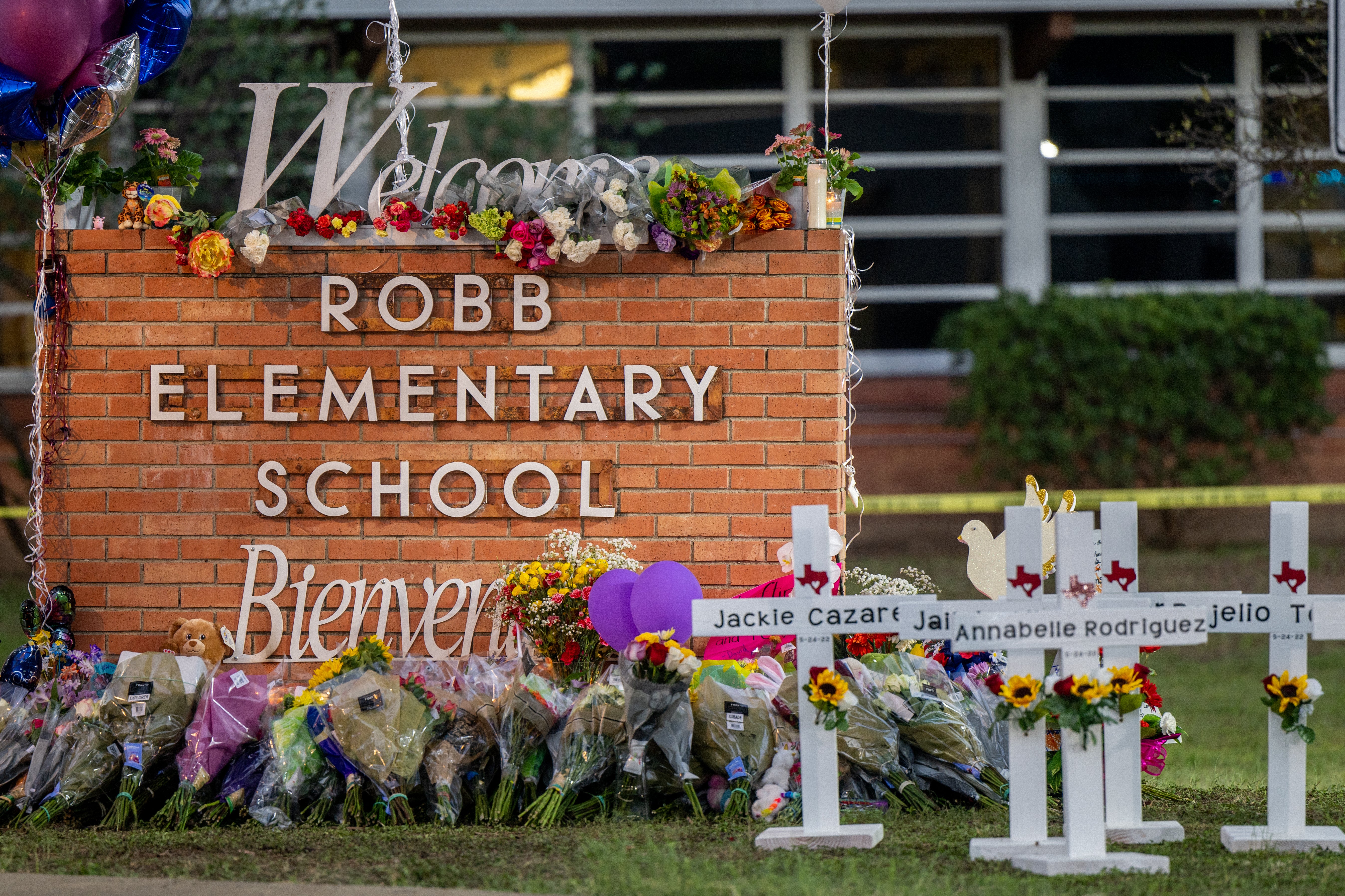 A memorial surrounding the Robb Elementary School sign following the mass shooting