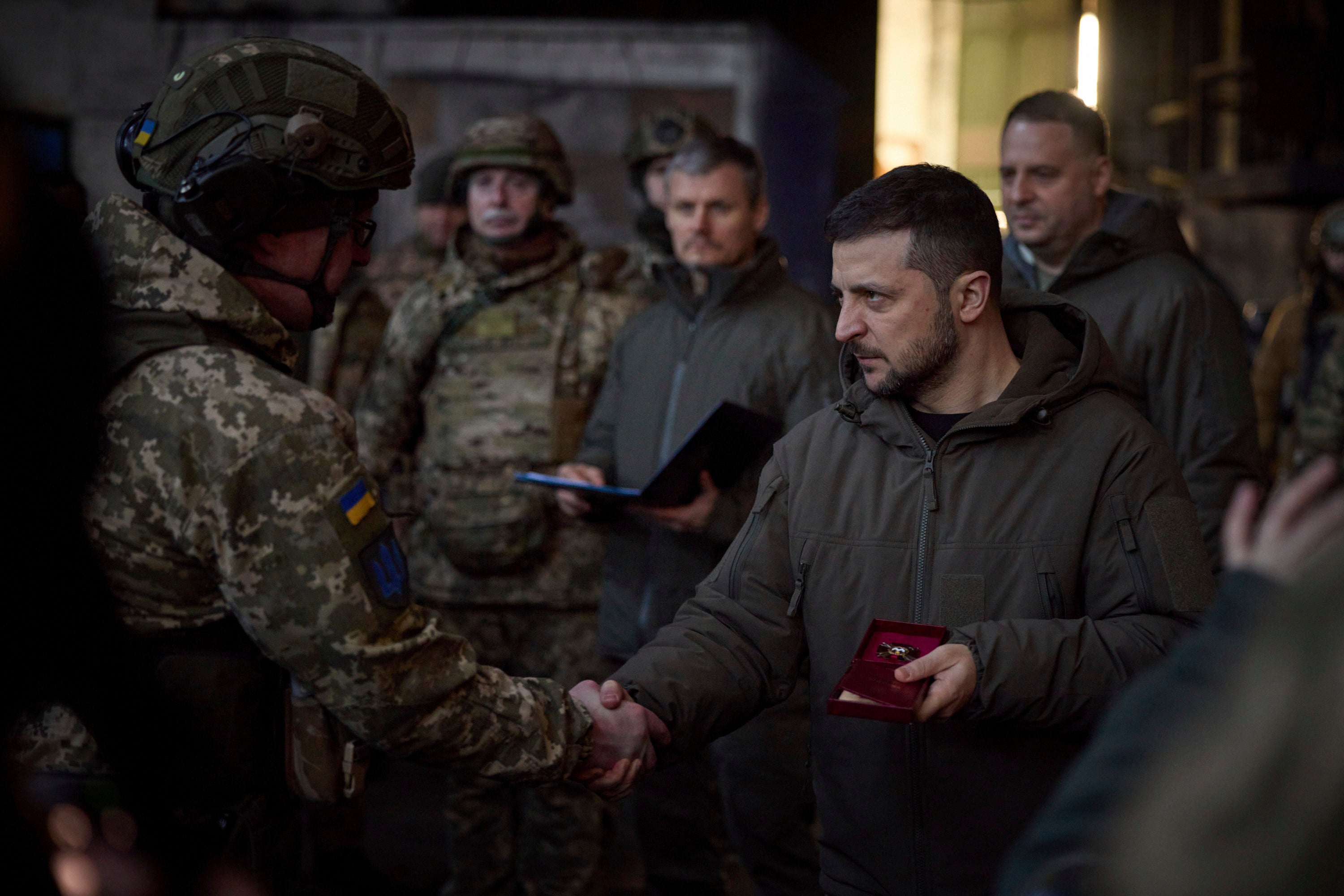 Ukrainian president Volodymyr Zelensky, right, awards a serviceman at the site of the heaviest battles with the Russian invaders in Bakhmut