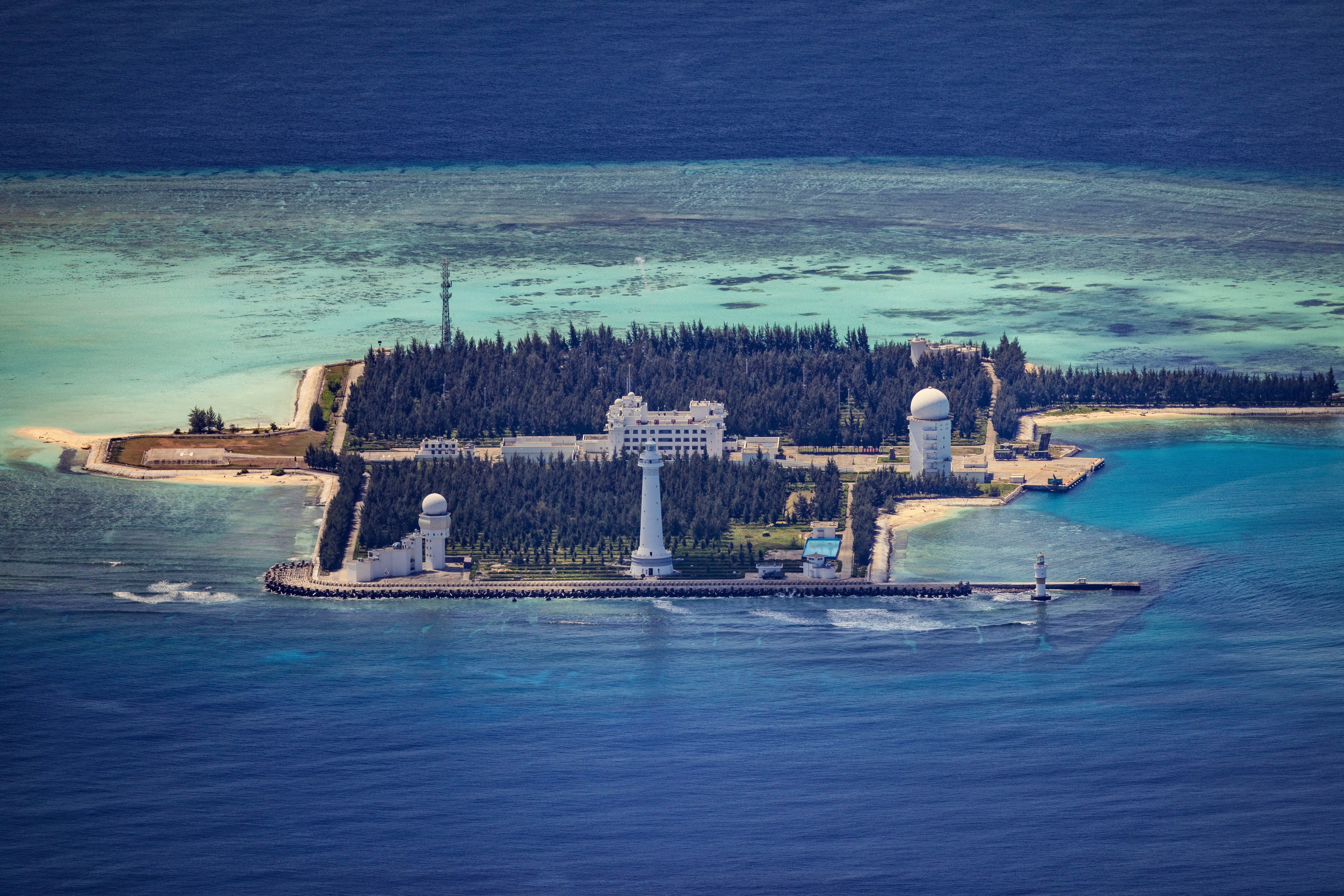 Buildings and structures are seen on the artificial island built by China in Cuarteron Reef on 25 October 2022 in Spratly Islands, South China Sea. China has progressively asserted its claim of ownership over disputed islands in the South China Sea by artificially increasing the size of islands, creating new islands and building ports, military outposts and airstrips. The South China sea is an important trade route and is of significant interest as geopolitical tensions remain high in the region