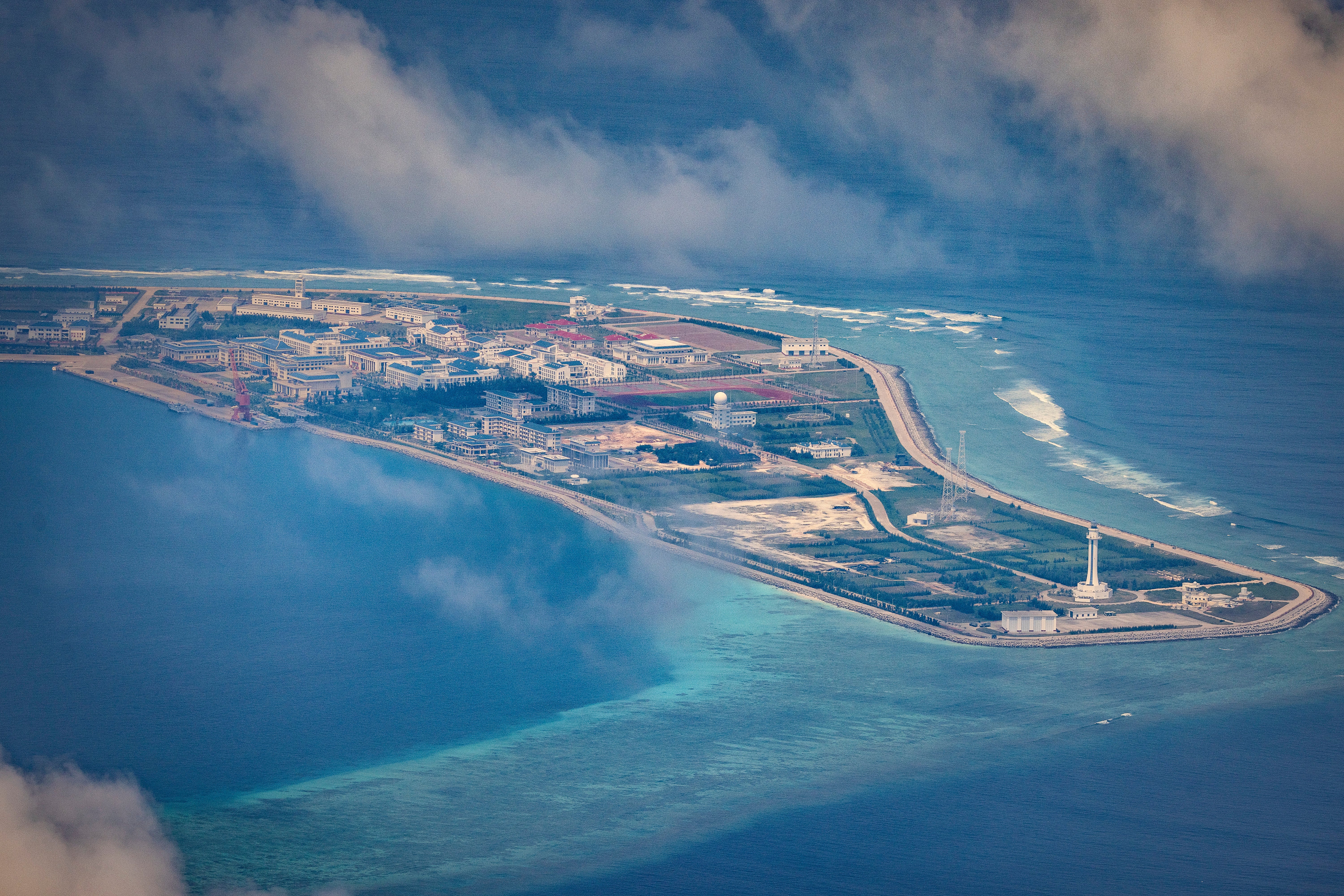 Buildings and structures are seen on the artificial island built by China in Subi Reef on 25 October 2022 in Spratly Islands, South China Sea. China has progressively asserted its claim of ownership over disputed islands in the South China Sea by artificially increasing the size of islands, creating new islands and building ports, military outposts and airstrips. The South China sea is an important trade route and is of significant interest as geopolitical tensions remain high in the region