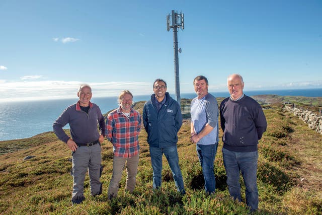 Cape Clear islanders and Vantage Towers chief executive Vivek Badrinath at the site of the new mast (Micheal MacSweeney/PA)