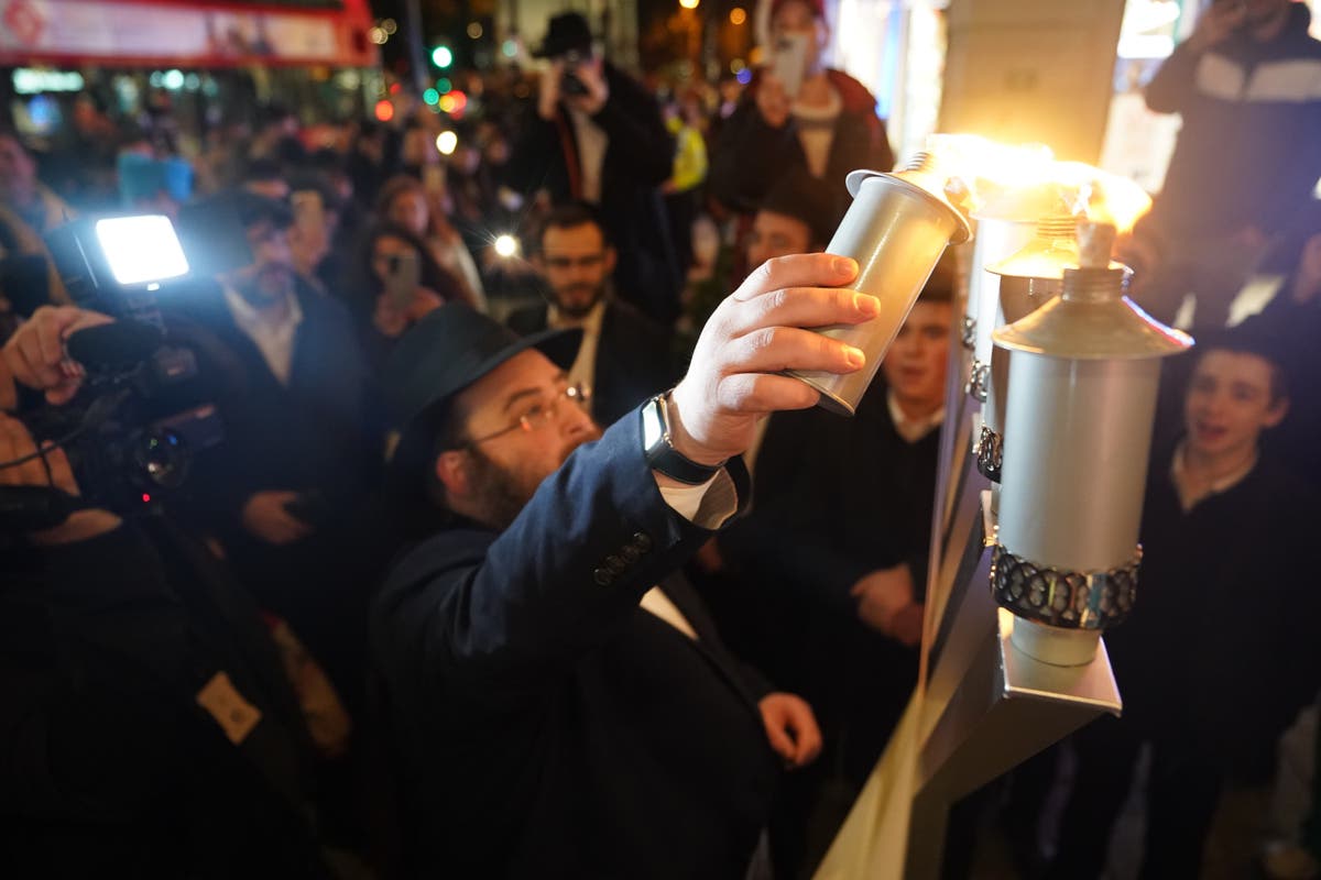 Group subjected to antisemitic attack return to scene to celebrate Hanukkah