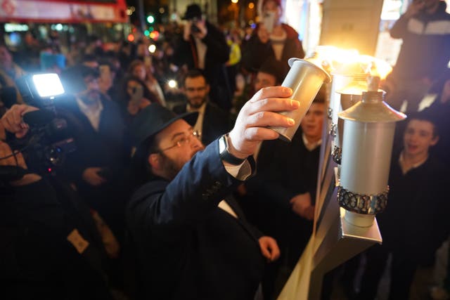 Members of the Jewish community lit candles on Oxford Street in London on the anniversary of the attack (James Manning/PA)