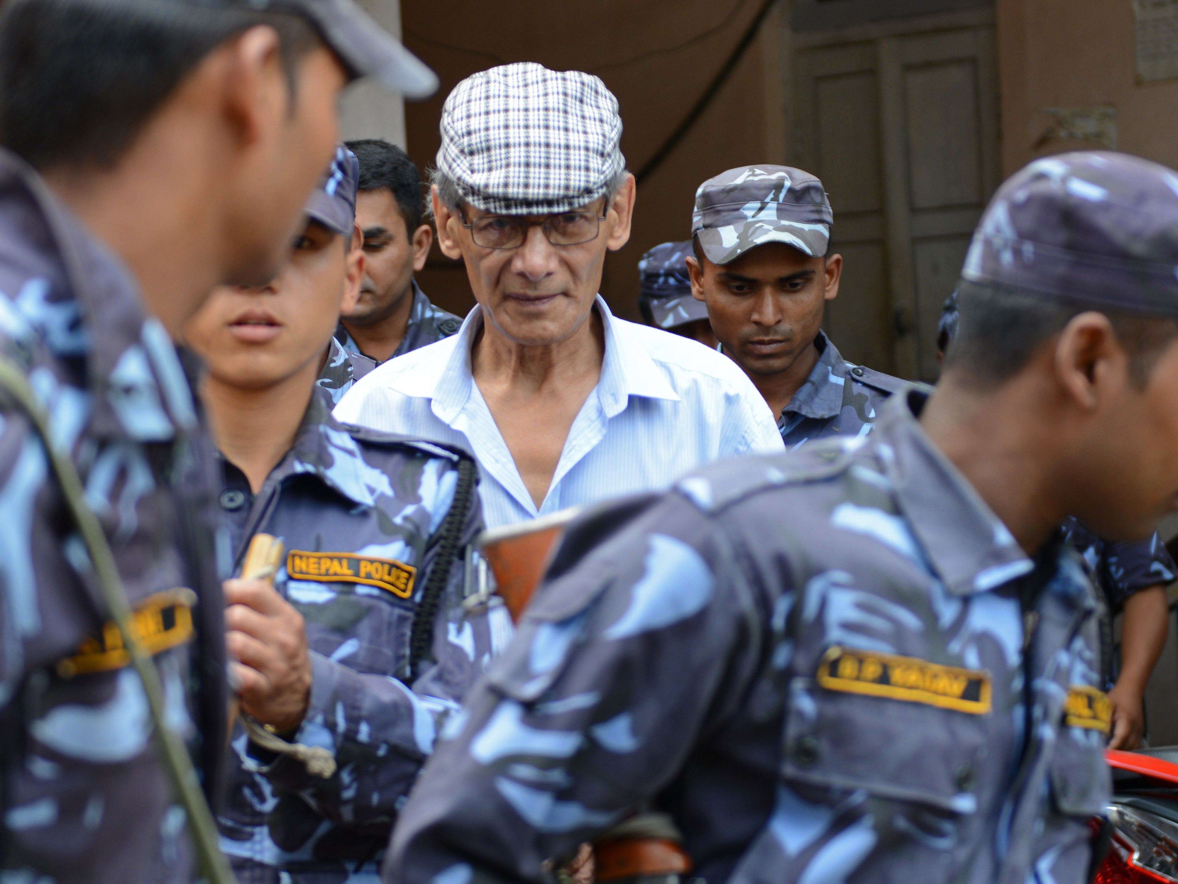 French serial killer Charles Sobhraj (centre) is escorted by Nepalese police in 2014