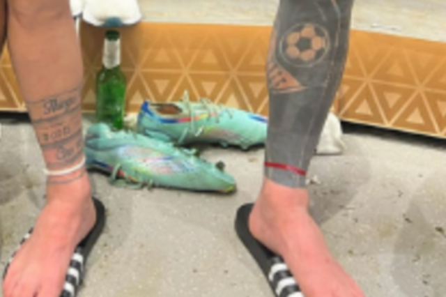 <p>Lionel Messi sports a red ribbon in the dressing room after the game</p>