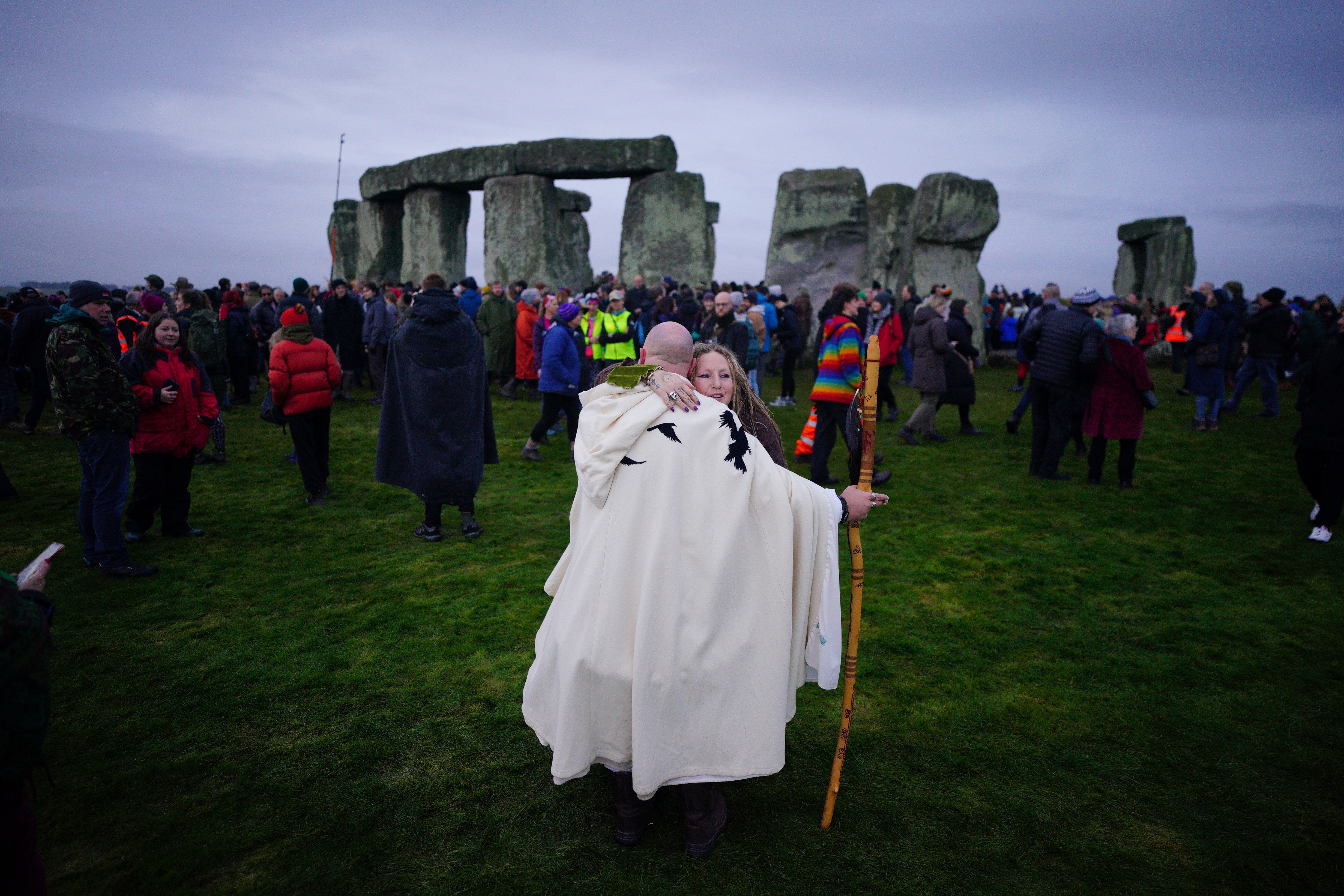 People take part in the winter solstice celebrations during sunrise at Stonehenge (Ben Birchall/PA)