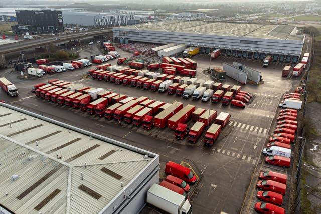 Royal Mail delivery vehicles and cages of mail at the Bristol Filton office (Ben Birchall/PA)