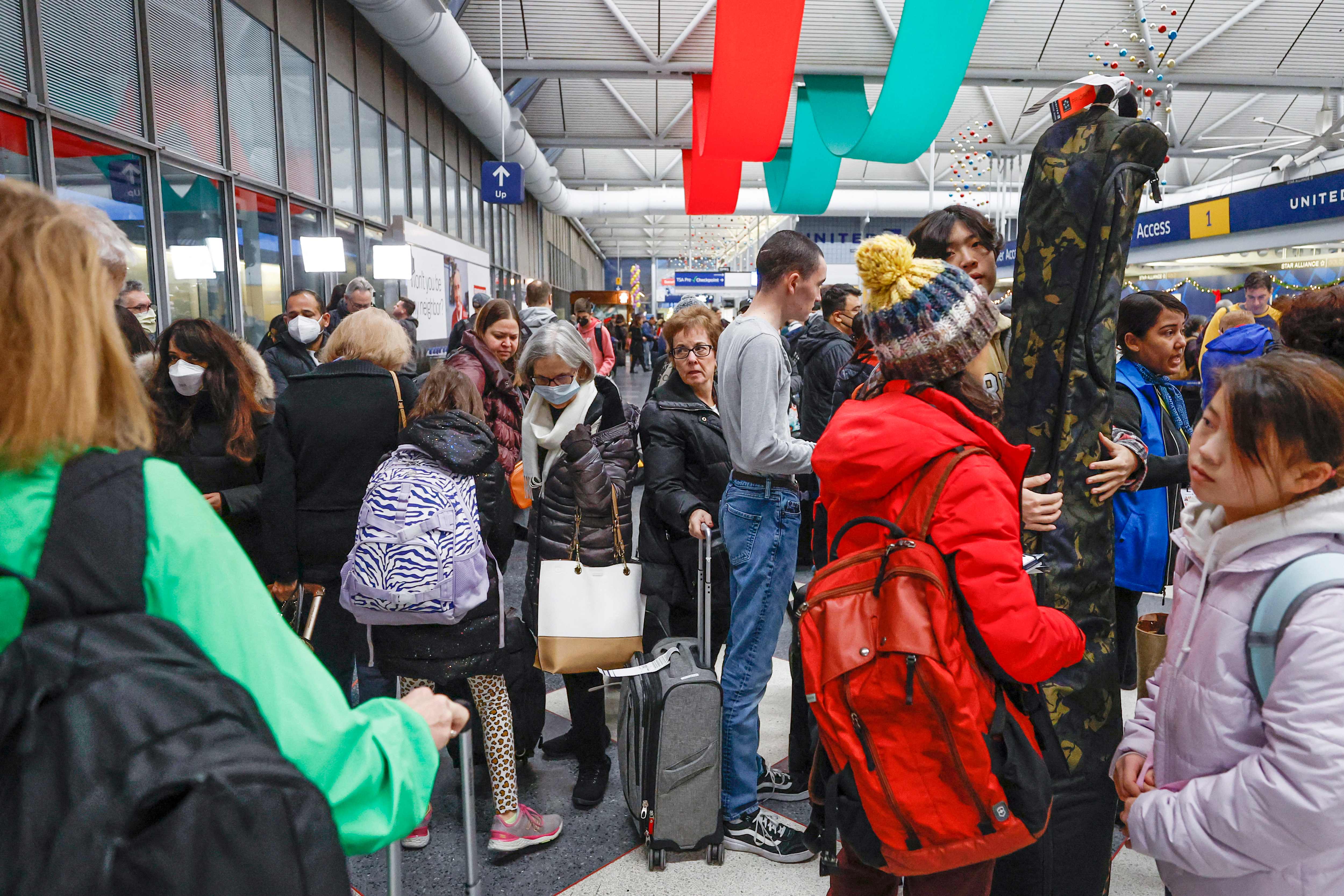 Travellers arrive for their flights at United Airlines Terminal 1 ahead of the Christmas Holiday at O’Hare International Airport