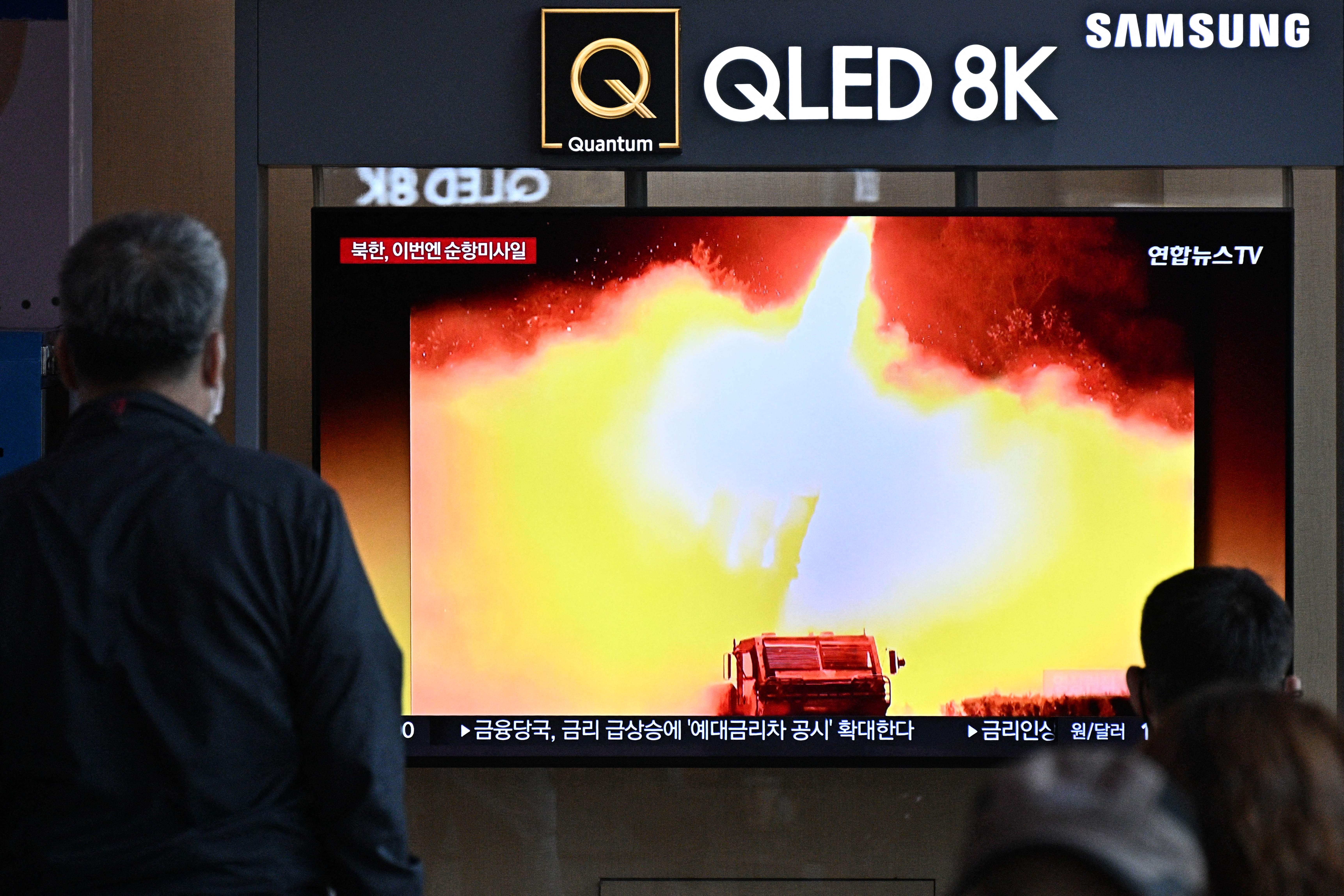 A man watches a news broadcast showing a photo of a North Korean missile test, at a railway station in Seoul