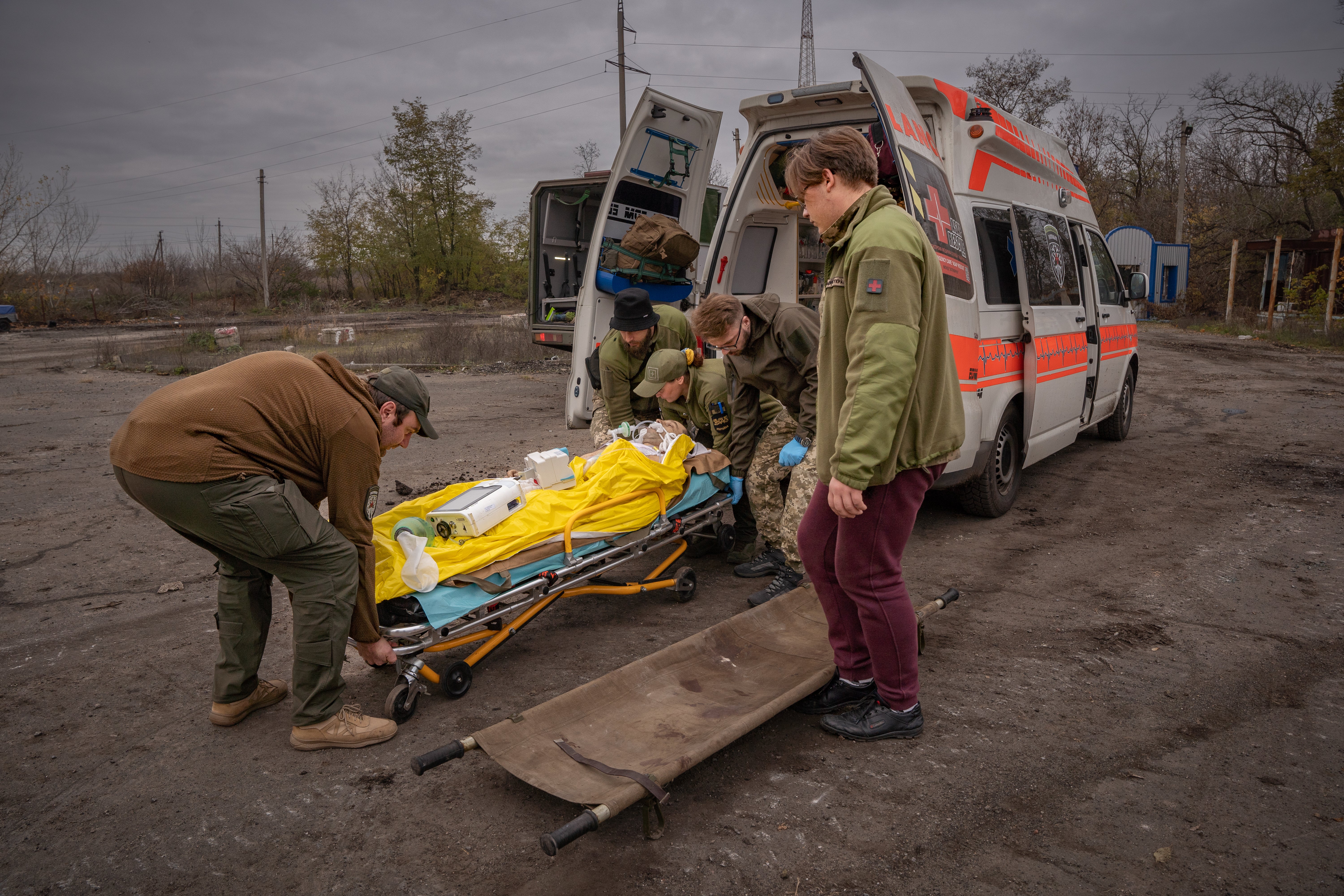 A critically injured patient is transferred by Kroha’s team near the frontline in Donbas