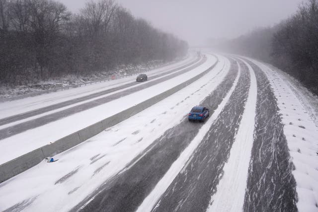 <p>Vehicles travel along Interstate 44 amid heavy snow as temperatures drop in St. Louis, Missouri from Winter Storm Elliott </p>