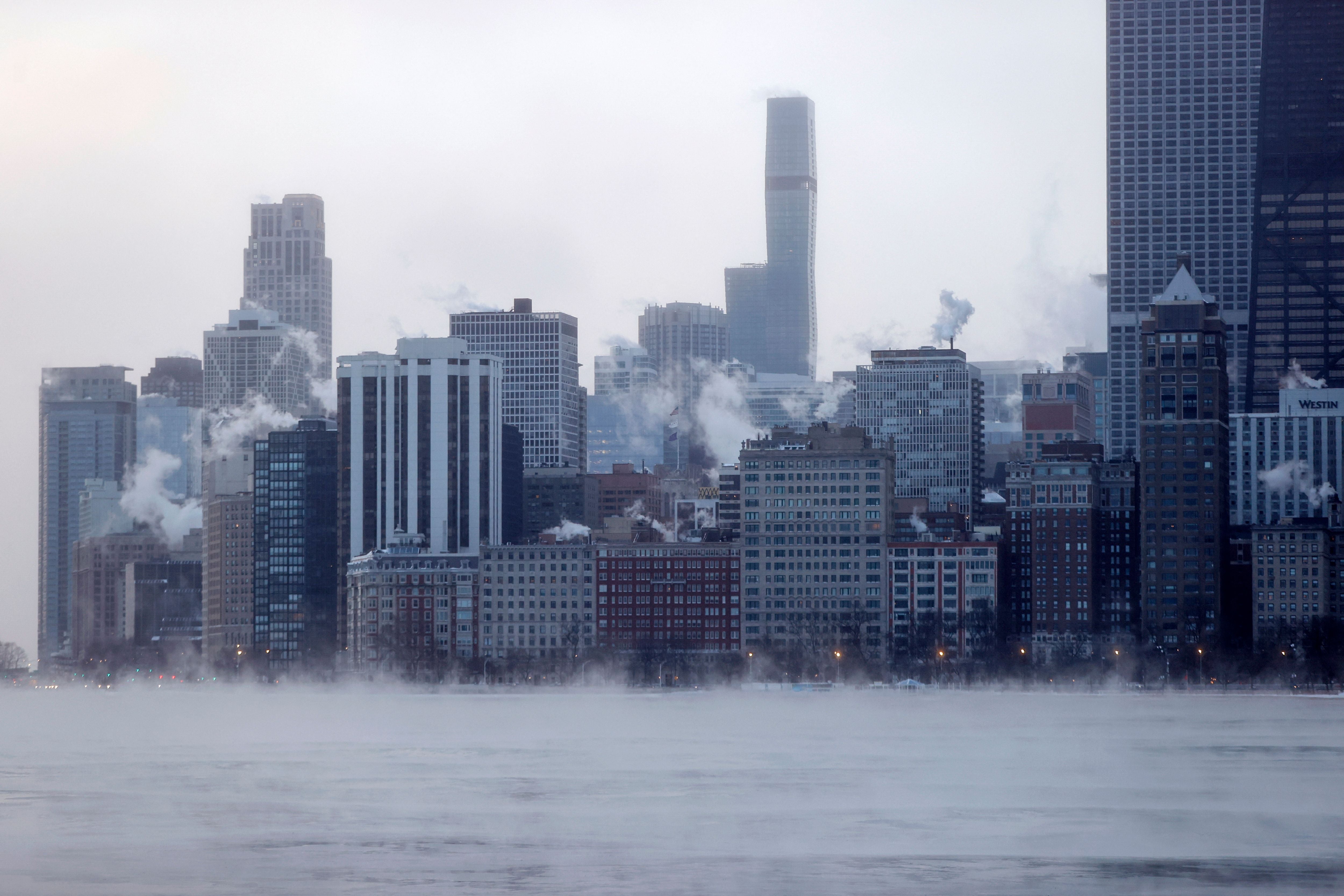 Mist rises from the ‘windy’ city of Chicago on the edge of Lake Michigan at sunrise on December 23, 2022, where temperatures reached -6F (-21C), ahead of the Christmas Holiday