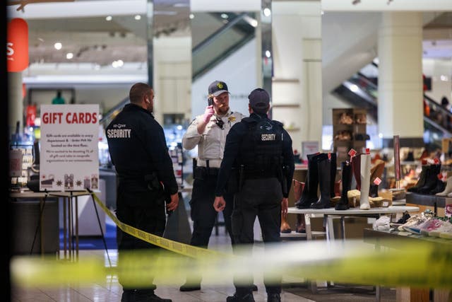 <p>Security officers speak inside a store at the Mall of America in Bloomington, Minnesota after a shooting on Friday </p>