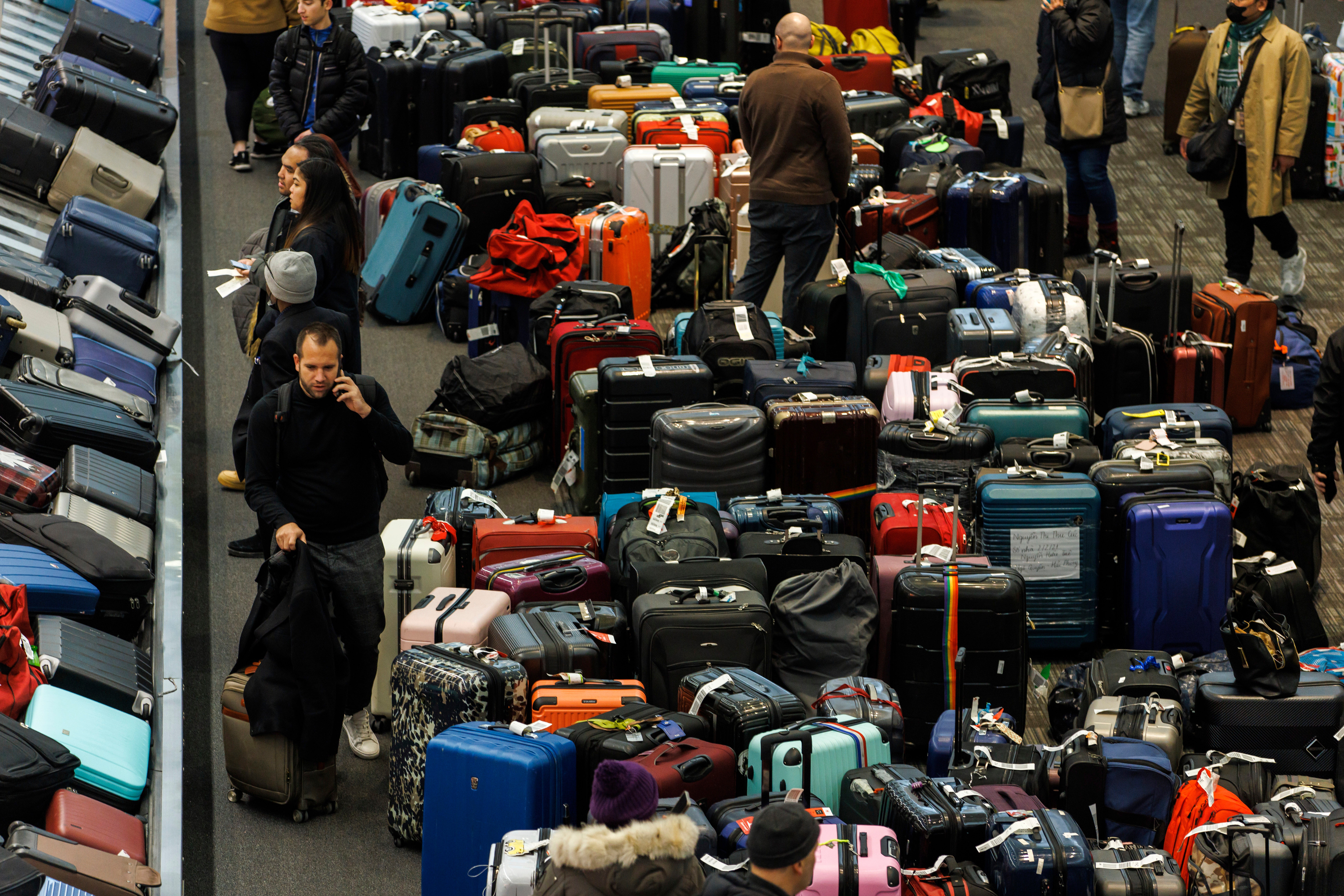 Luggage bags are amassed in the bag claim area at Toronto Pearson International Airport, as a major winter storm disrupts flights in and out of the airport, in Toronto, Saturday, Dec. 24, 2022