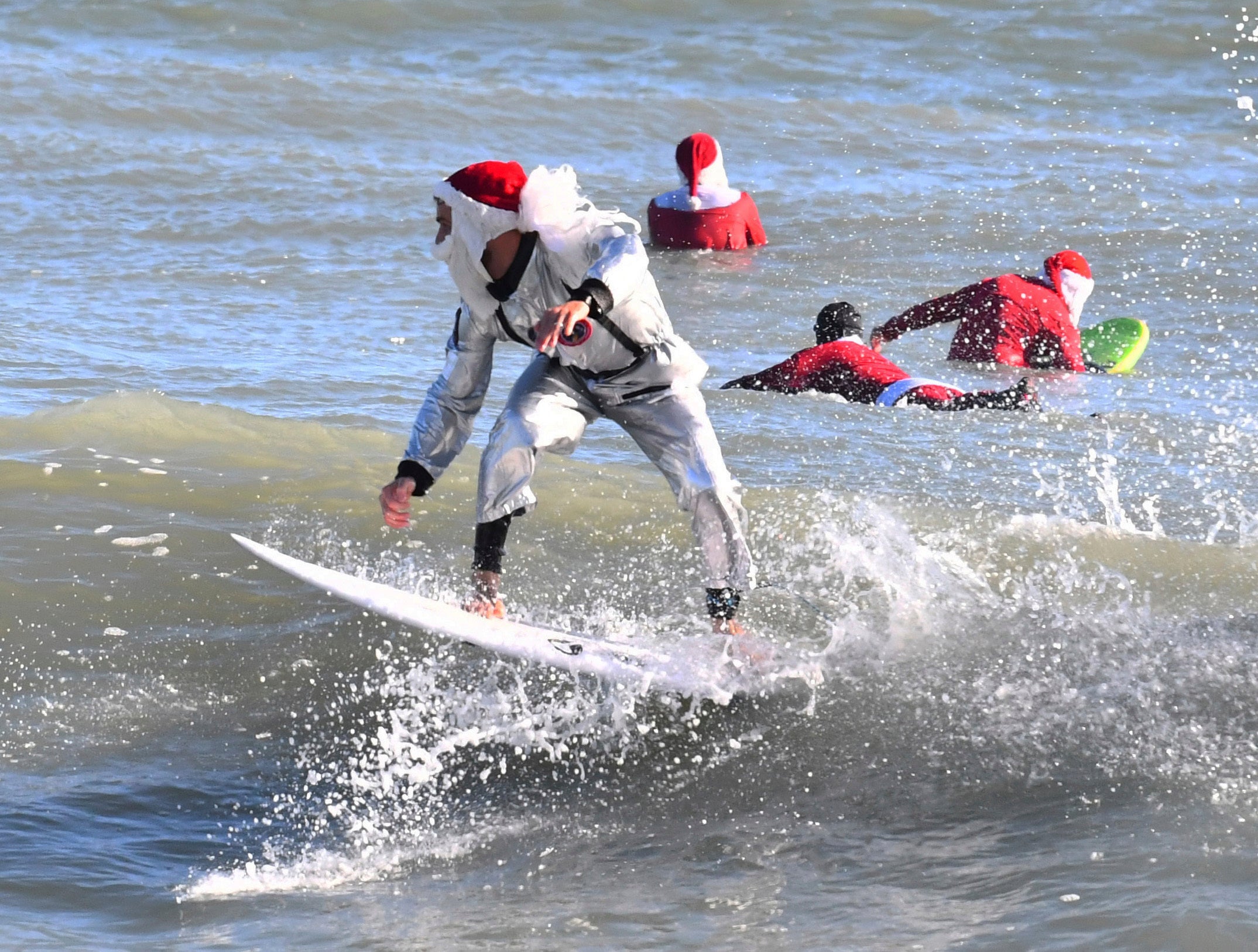Frigid weather doesnt stop Santas surfing off Florida coast The Independent photo