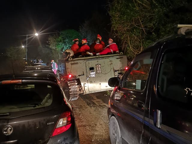 <p>An image taken by Lee Gribble shows the group of Santas somewhat submerged in a hedge near Hayle</p>