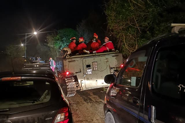 <p>An image taken by Lee Gribble shows the group of Santas somewhat submerged in a hedge near Hayle</p>
