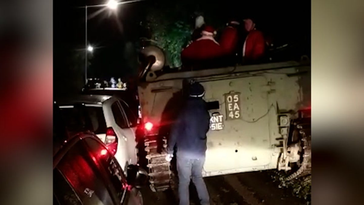 Pub-crawling Santas block Cornish road after getting army tank stuck in hedge