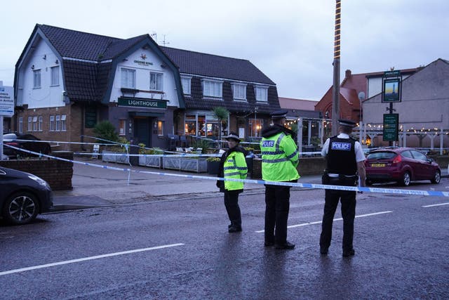 <p>Police at the Lighthouse Inn in Wallasey following the fatal shooting</p>