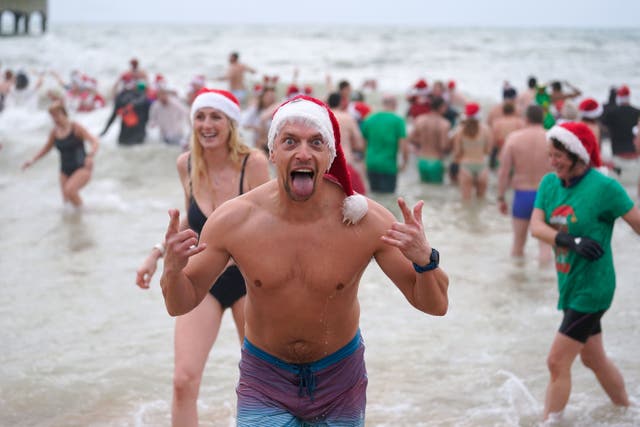 Swimmers take part in the Macmillan Boscombe White Christmas Dip (Andrew Matthews/PA)