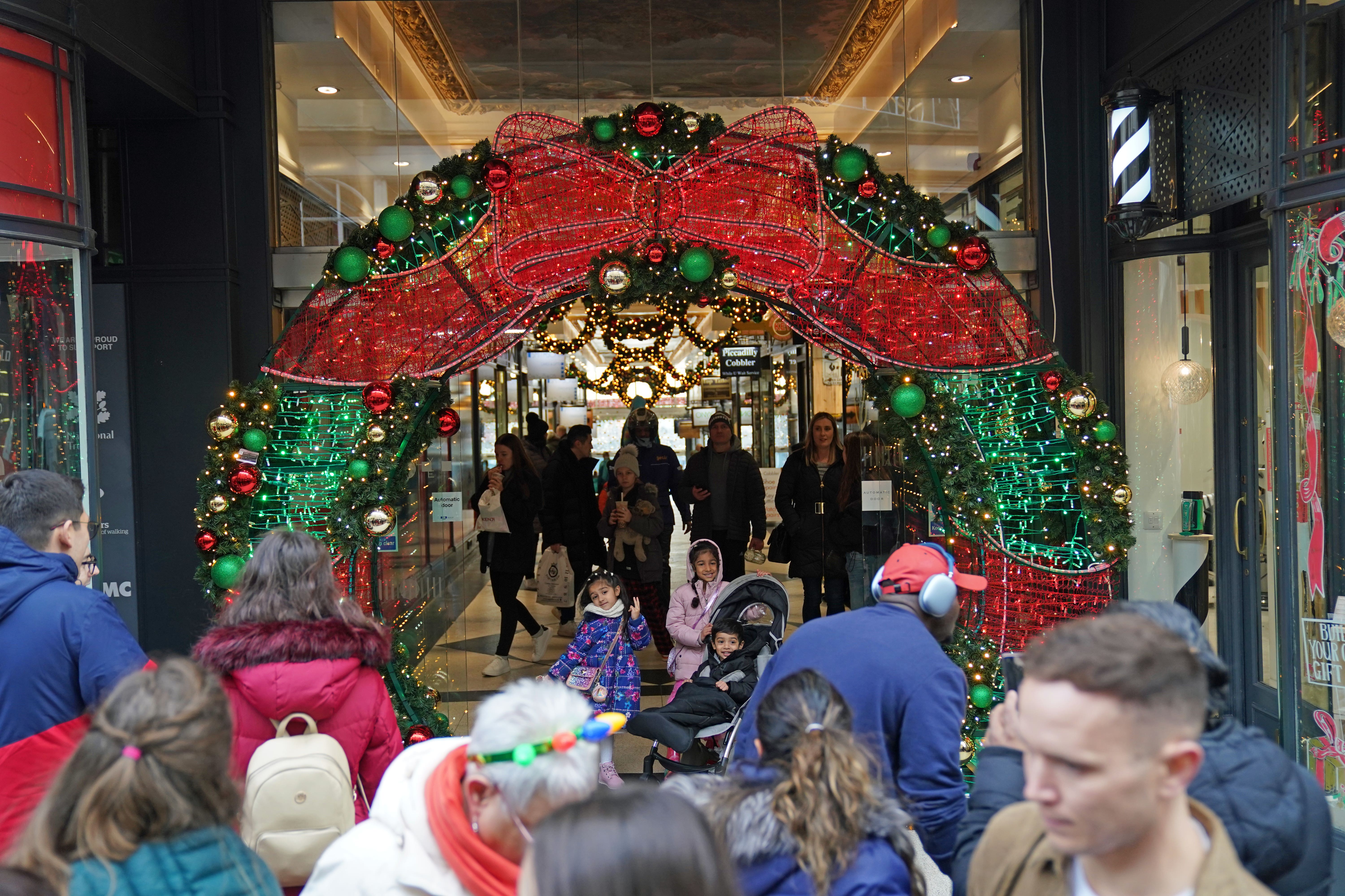 Shoppers in Piccadilly Arcade, Birmingham do some Christmas shopping (Jacob King/PA)