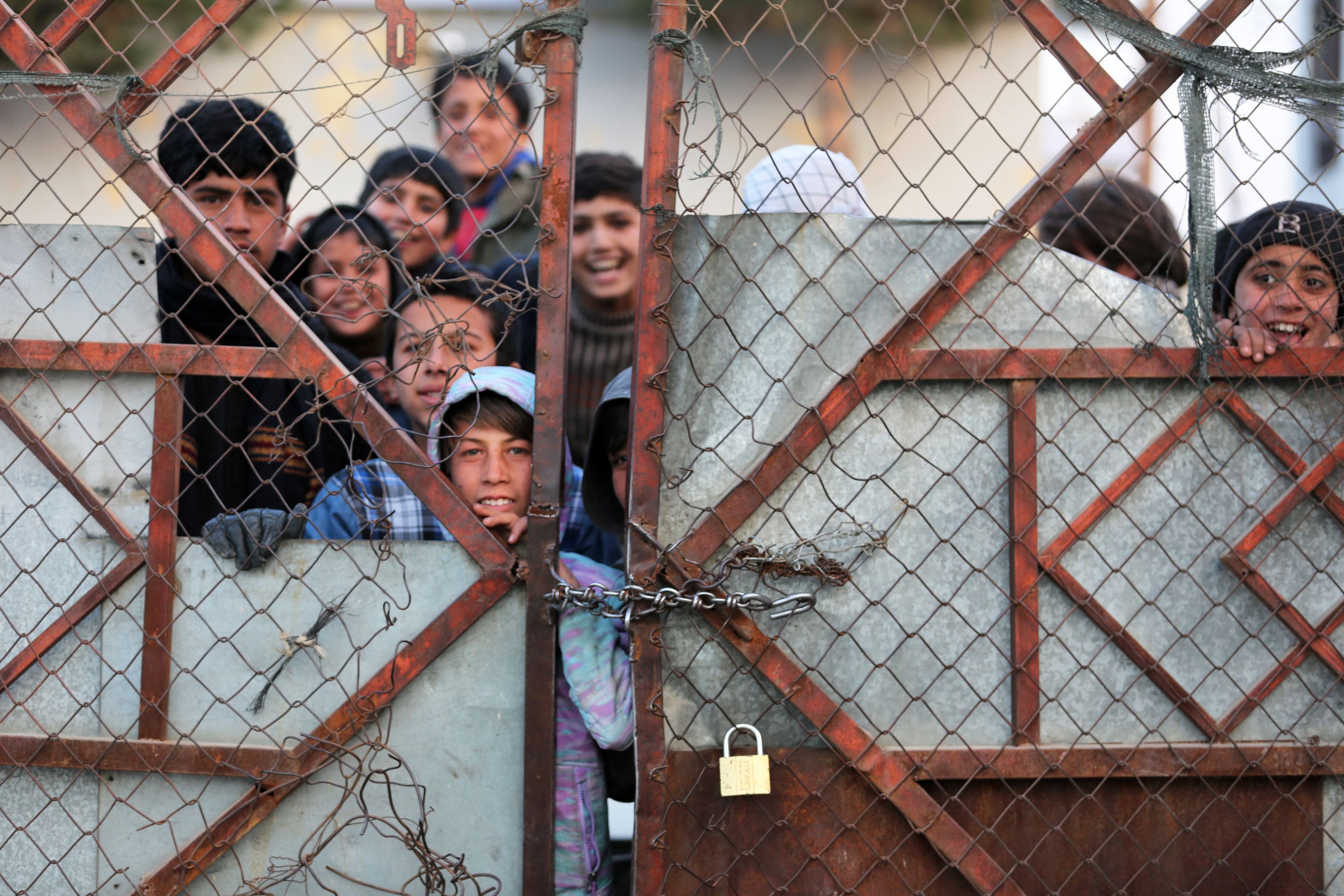 <p>Afghan people stand in queues to receive food aid from a non-governmental organisation (NGO) in Kabul on 25 December</p>