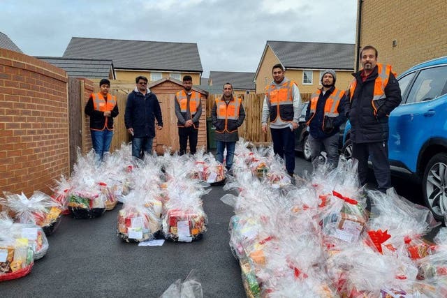 The Ahmadiyya Muslim Youth Association has been delivering hundreds of gift baskets, in partnership with Marie Curie, to those spending the festive period alone or struggling with the cost-of-living crisis (Amya/PA)