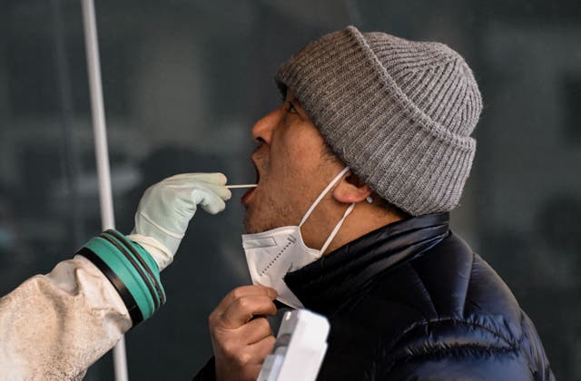 <p>A man is tested for Covid-19 at a hospital in Beijing on Monday</p>