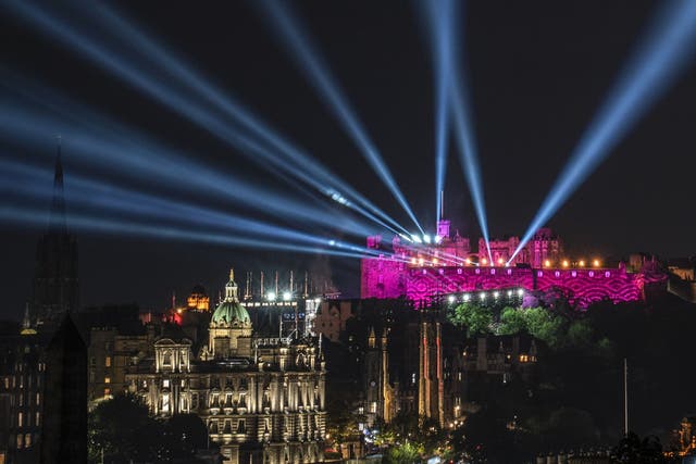 Laser beams and projections light up Edinburgh Castle during the Royal Edinburgh Military Tattoo in August (Jane Barlow/PA)