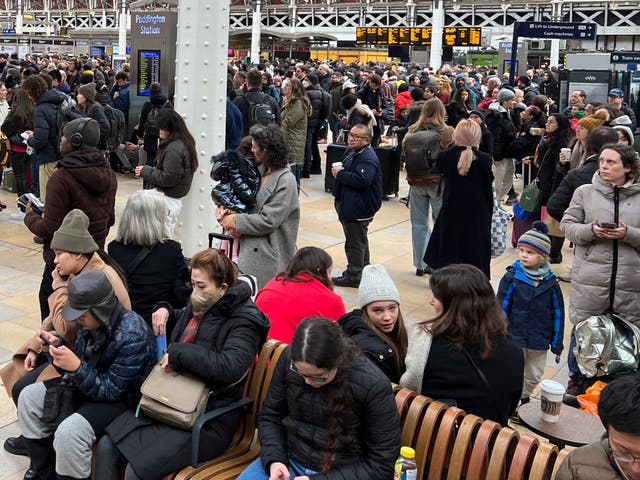 <p>Waiting game: Passengers at London Paddington station</p>