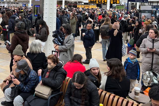 <p>Waiting game: Passengers at London Paddington station</p>