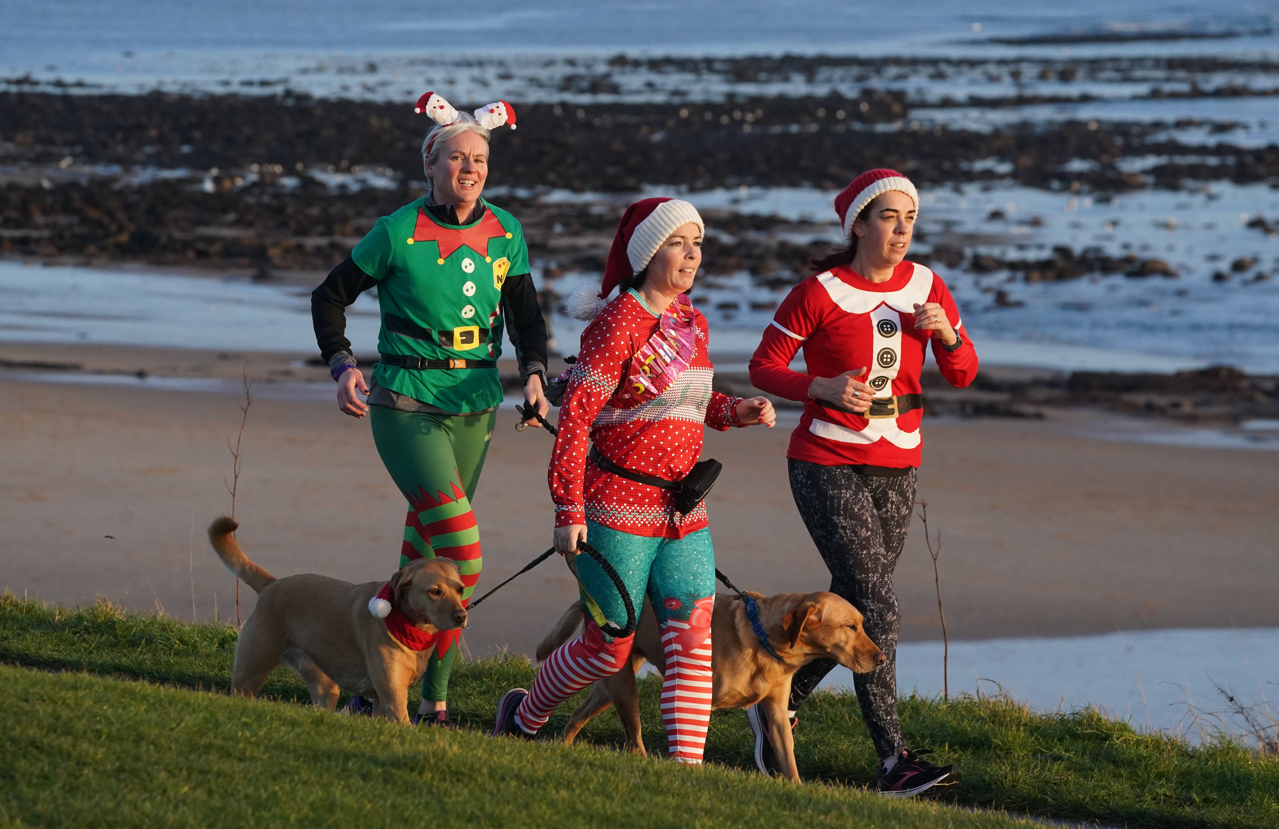 Runners dressed in festive outifits take part in the Christmas Eve park run at Whitley Bay