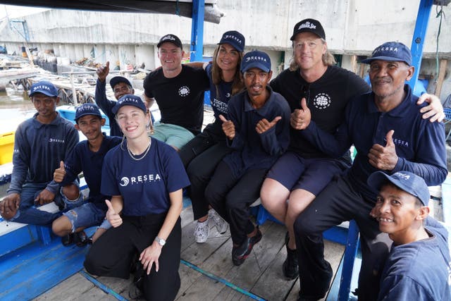 Entrepreneur Justin Moran (third right) and former Aussie rules footballer turned wine-maker Richie Vandenberg (sixth right) with workers from Danish firm, ReSea Project (Owen Humphreys/PA)