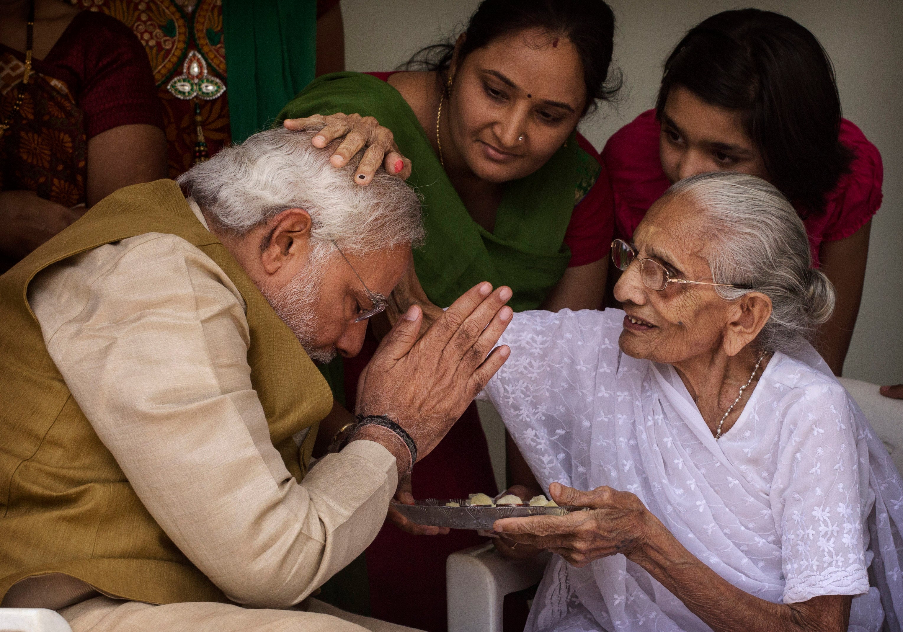 File: Narendra Modi with his mother Heeraben Modi on 16 May 2014 in Ahmedabad, India