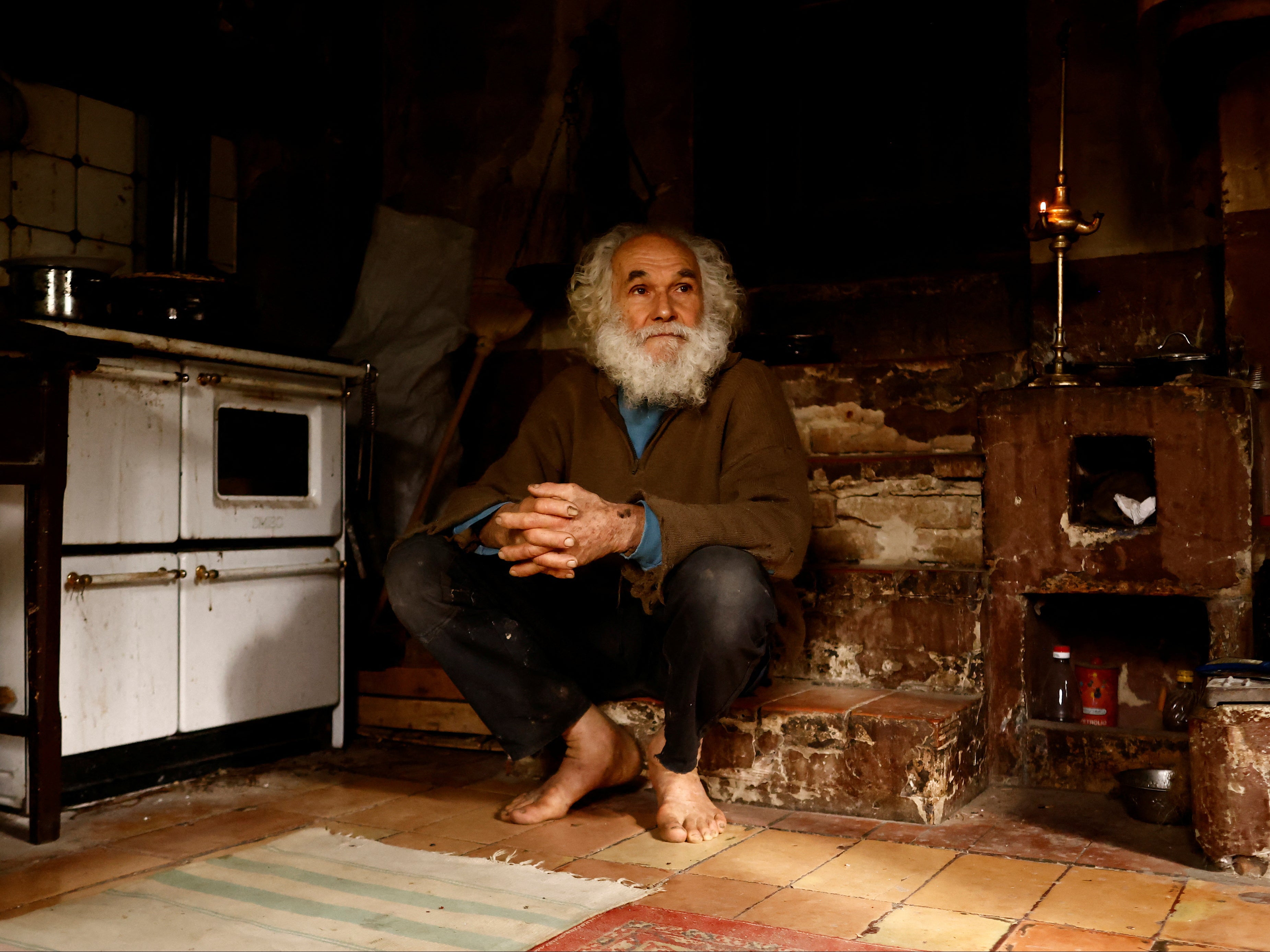 Fabrizio Cardinali sits on the stairs at his home in the woods of the small town of Cupramontana, Ancona, Marche, Italy