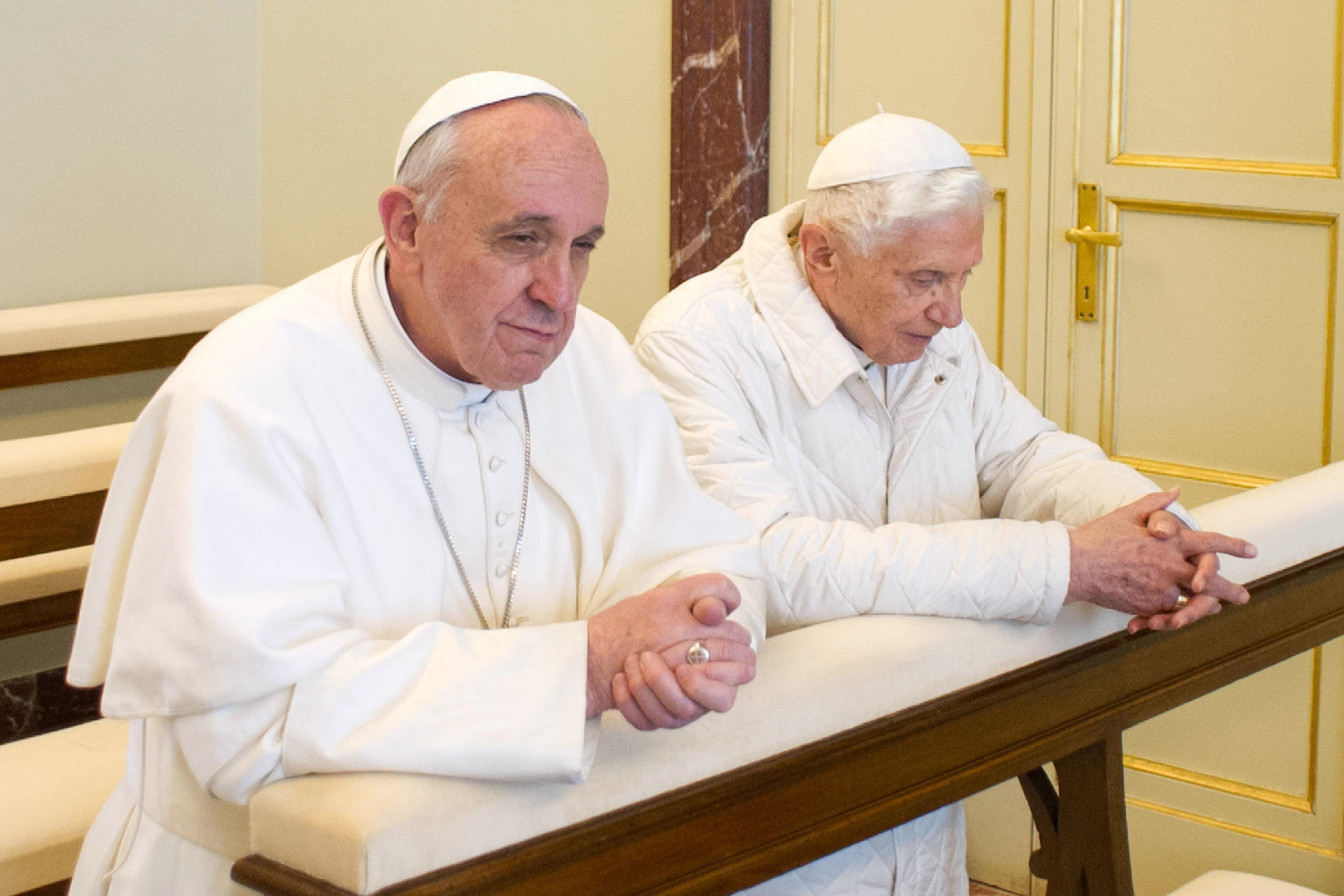 Pope Emeritus Benedict XVI (right) and Pope Francis praying in Castel Gandolfo in 2013