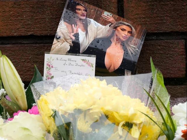 <p>Floral tributes to Ms Edwards reading ‘to a dear daughter’ </p>