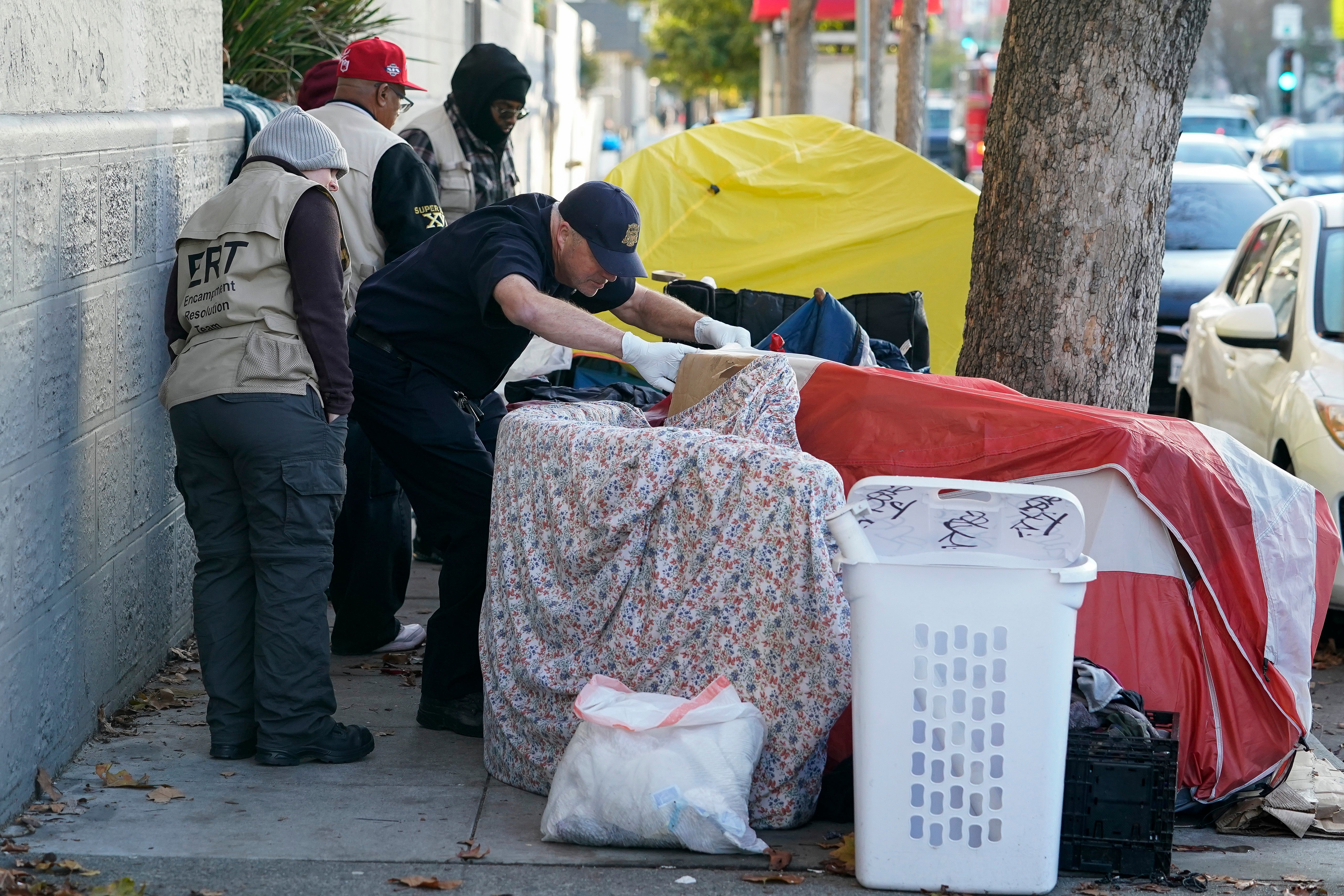 Members of the San Francisco Homeless Outreach Team’s Encampment Resolution Team speak to with homeless people in San Francisco in 2022 (file)